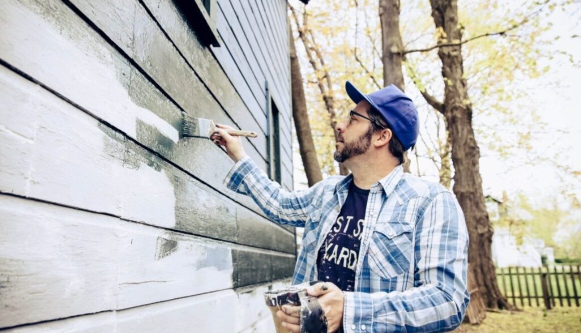 Side view of man painting exterior of home-min(1)