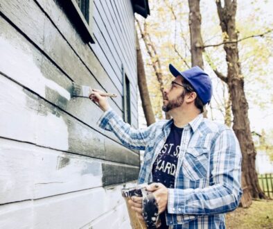 Side view of man painting exterior of home-min(1)