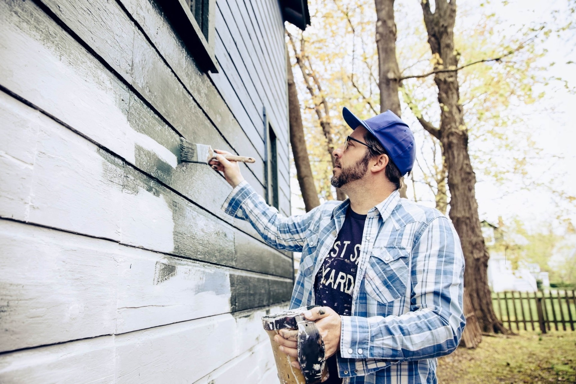 Side view of man painting exterior of home-min(1)